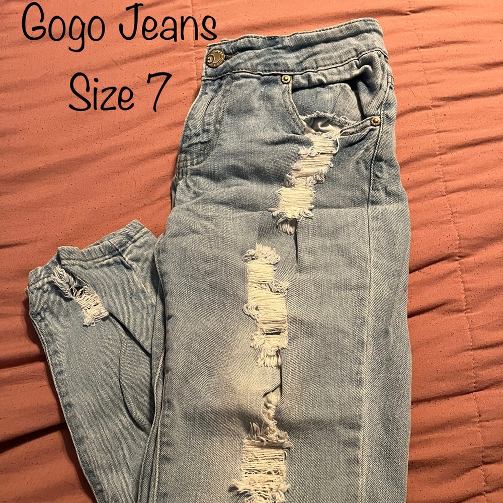 Ripped blue denim boot cut jeans
